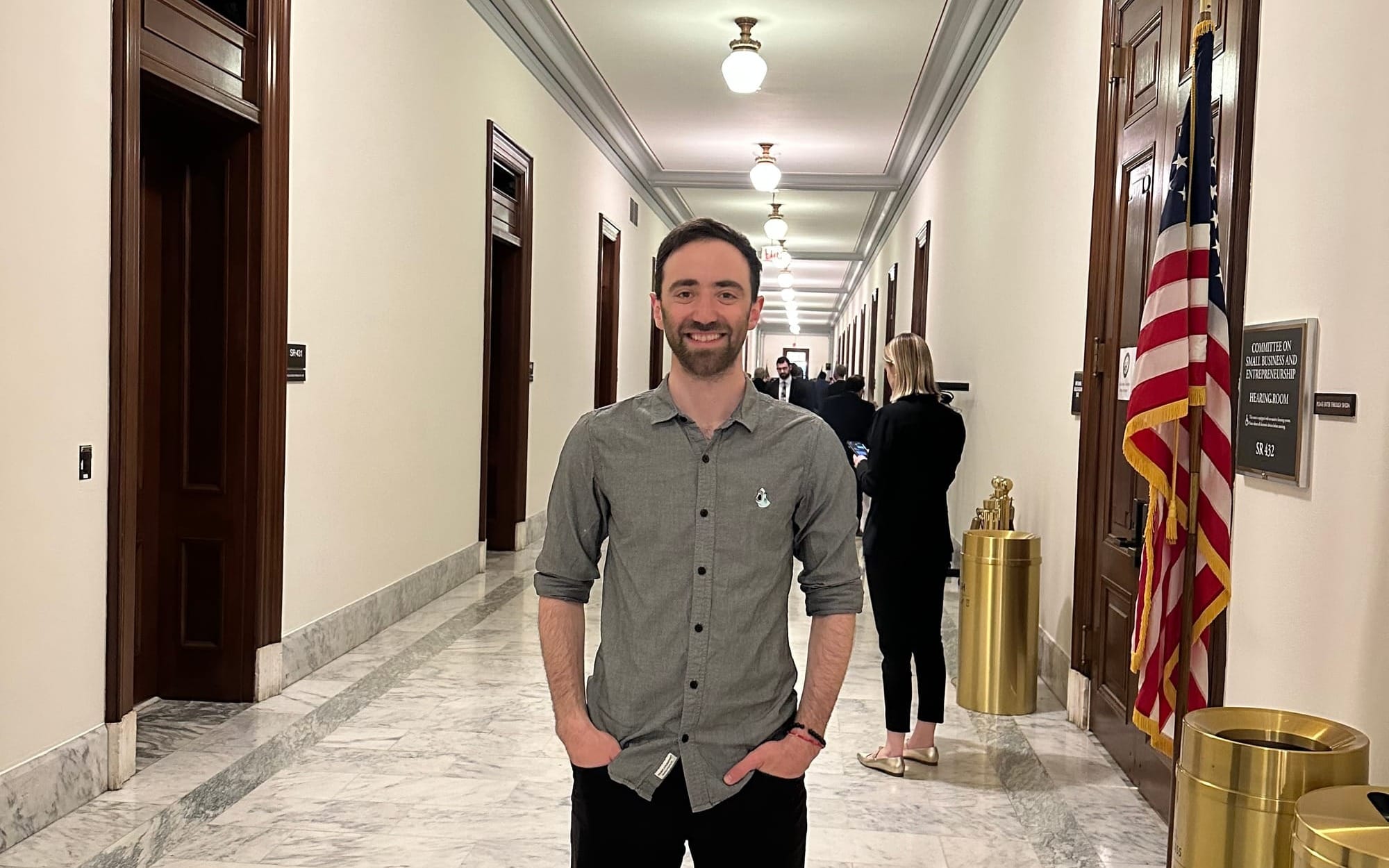 Jacob smiling in the hall of the Senate building