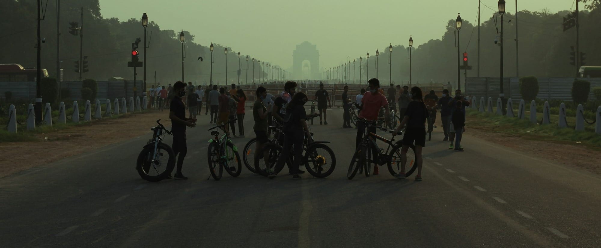 people riding bicycles on road during daytime