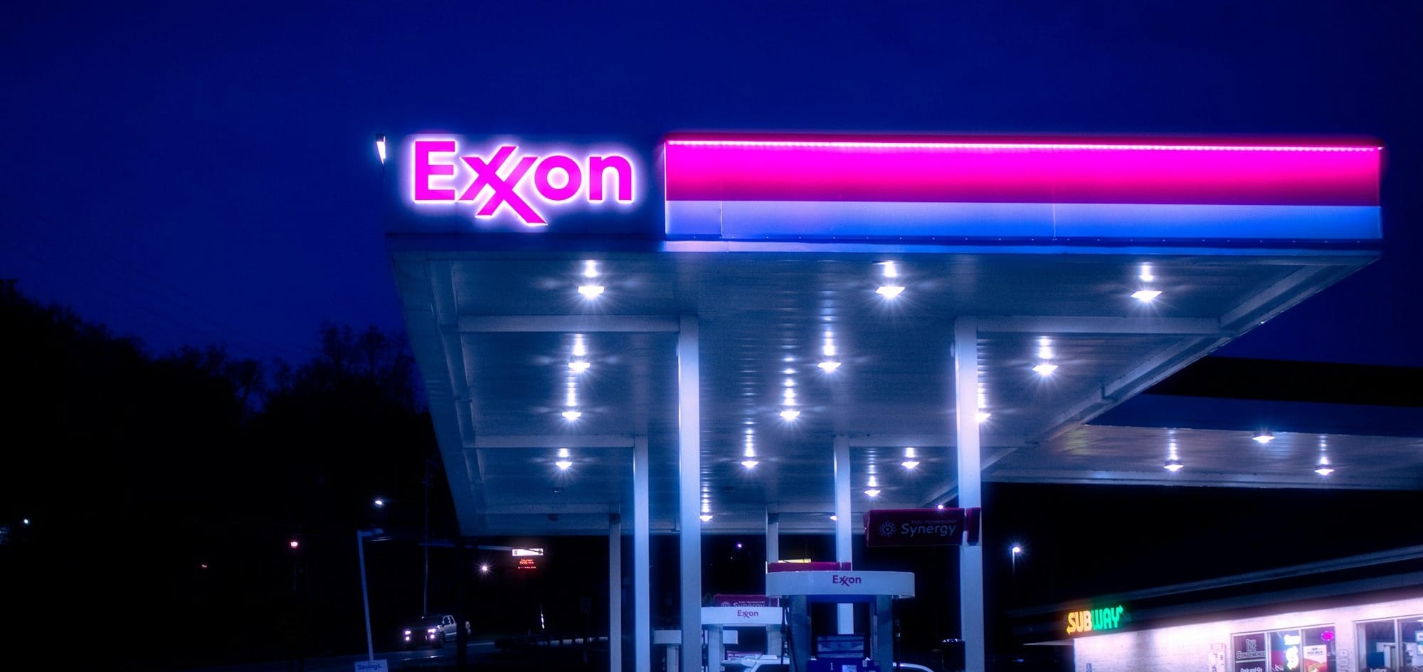 cars parked in front of UNKs store during night time