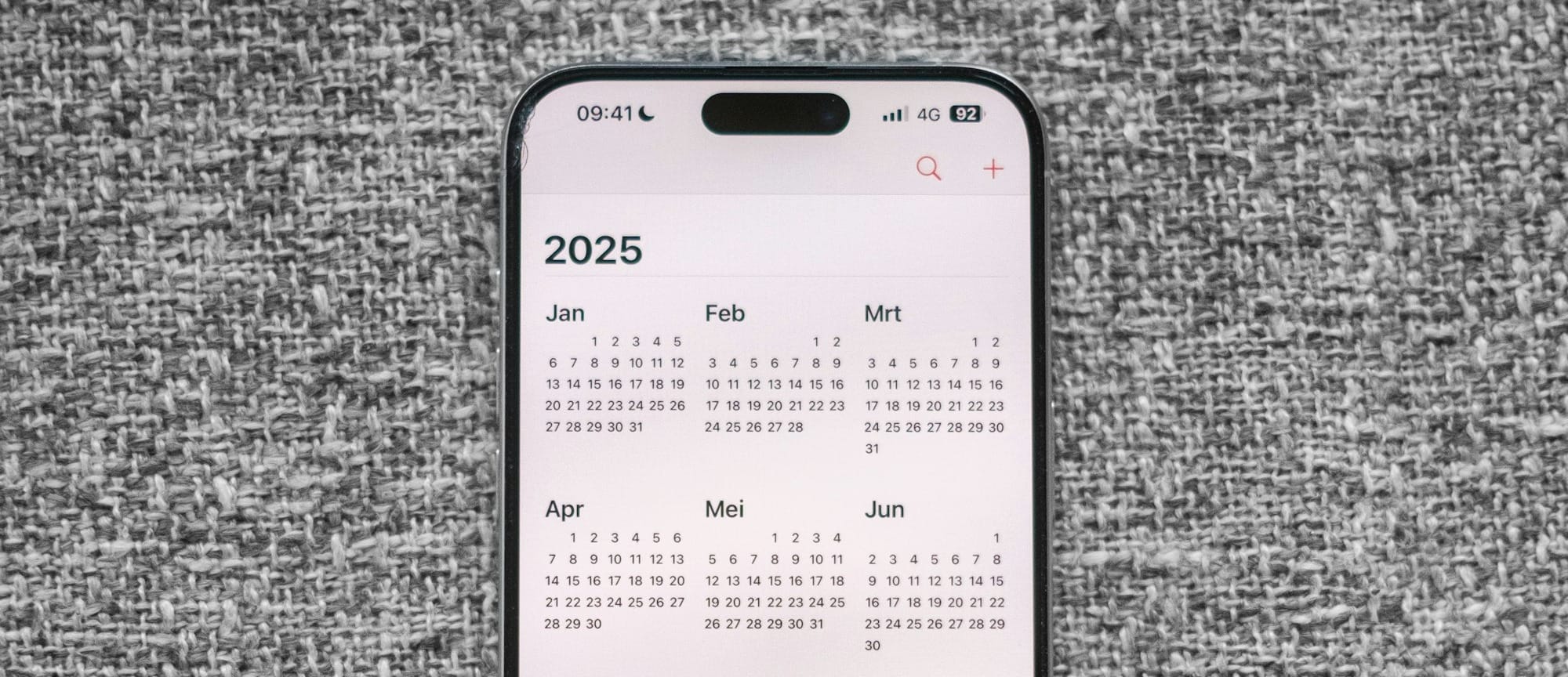 A white and black phone sitting on top of a gray surface